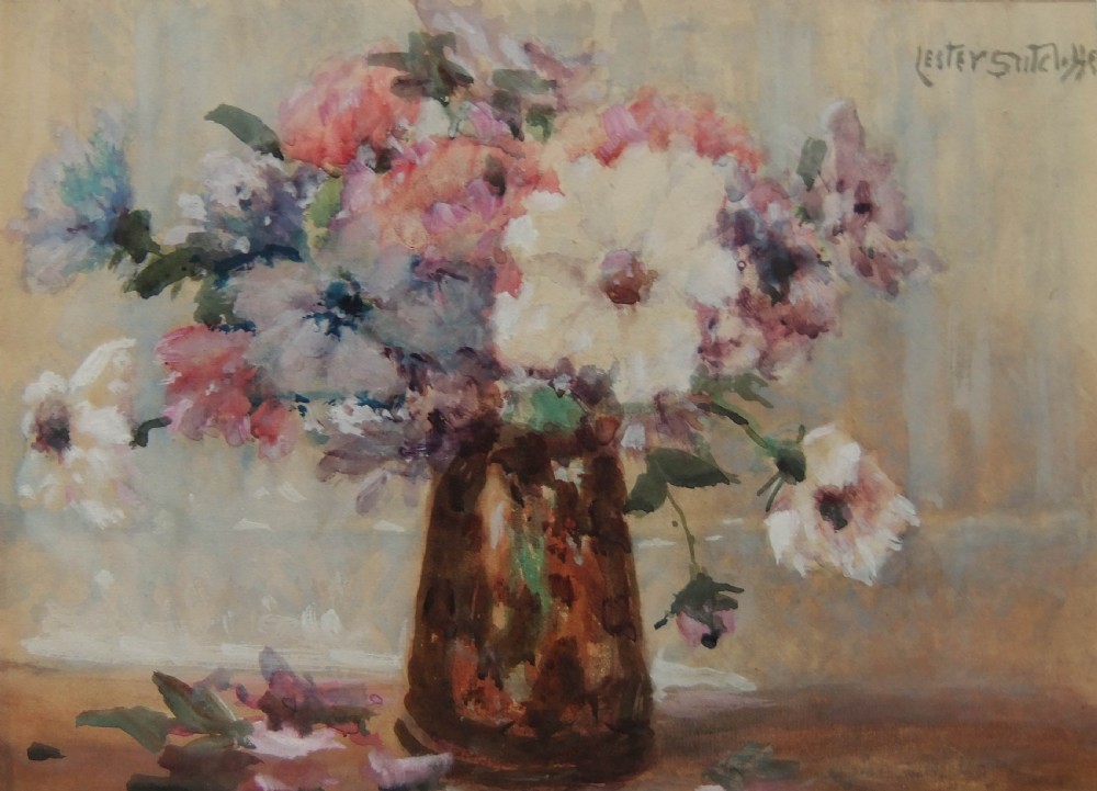 A watercolour painting depicting a vase filled with anemone blossoms in shades of pink, white, and purple against a neutral background, signed by Lester Sutcliffe.