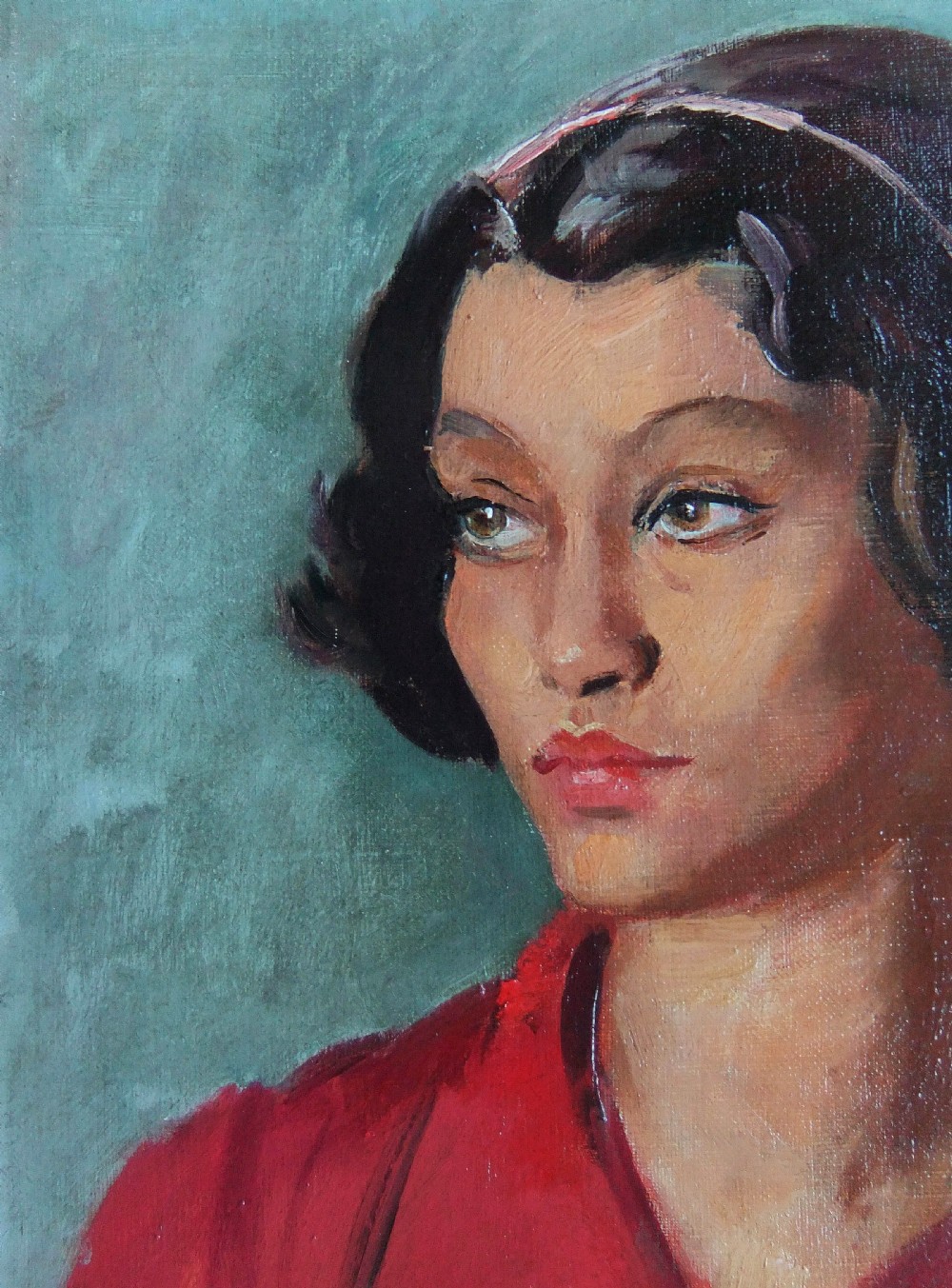 A framed oil painting depicting a young woman with dark short hair wearing a red top against a turquoise background. View II