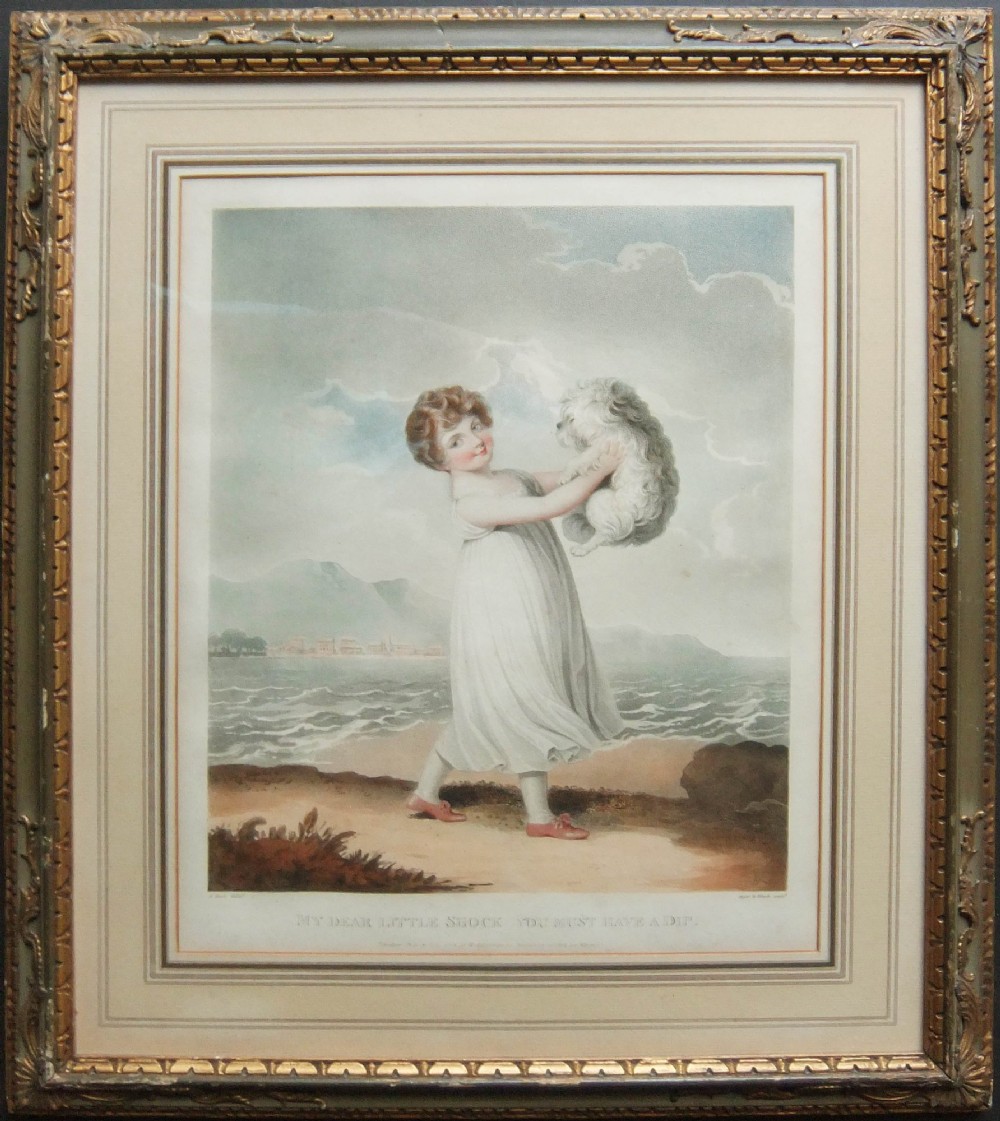A framed early 19th-century colour engraving by Adam Buck depicting a child holding a dog near the sea, set within a glazed gilt wood frame.