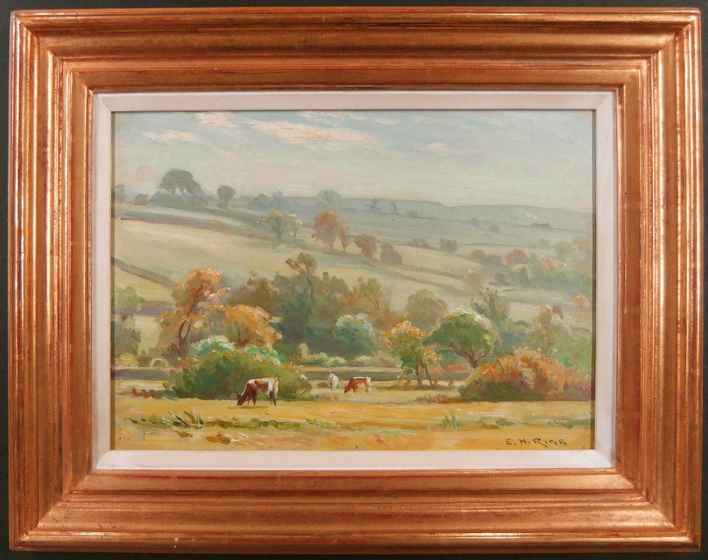 An impressionist landscape oil painting depicting cattle grazing in a field surrounded by trees and rolling hills under a soft sky, signed lower right E.H. Rigg. View II
