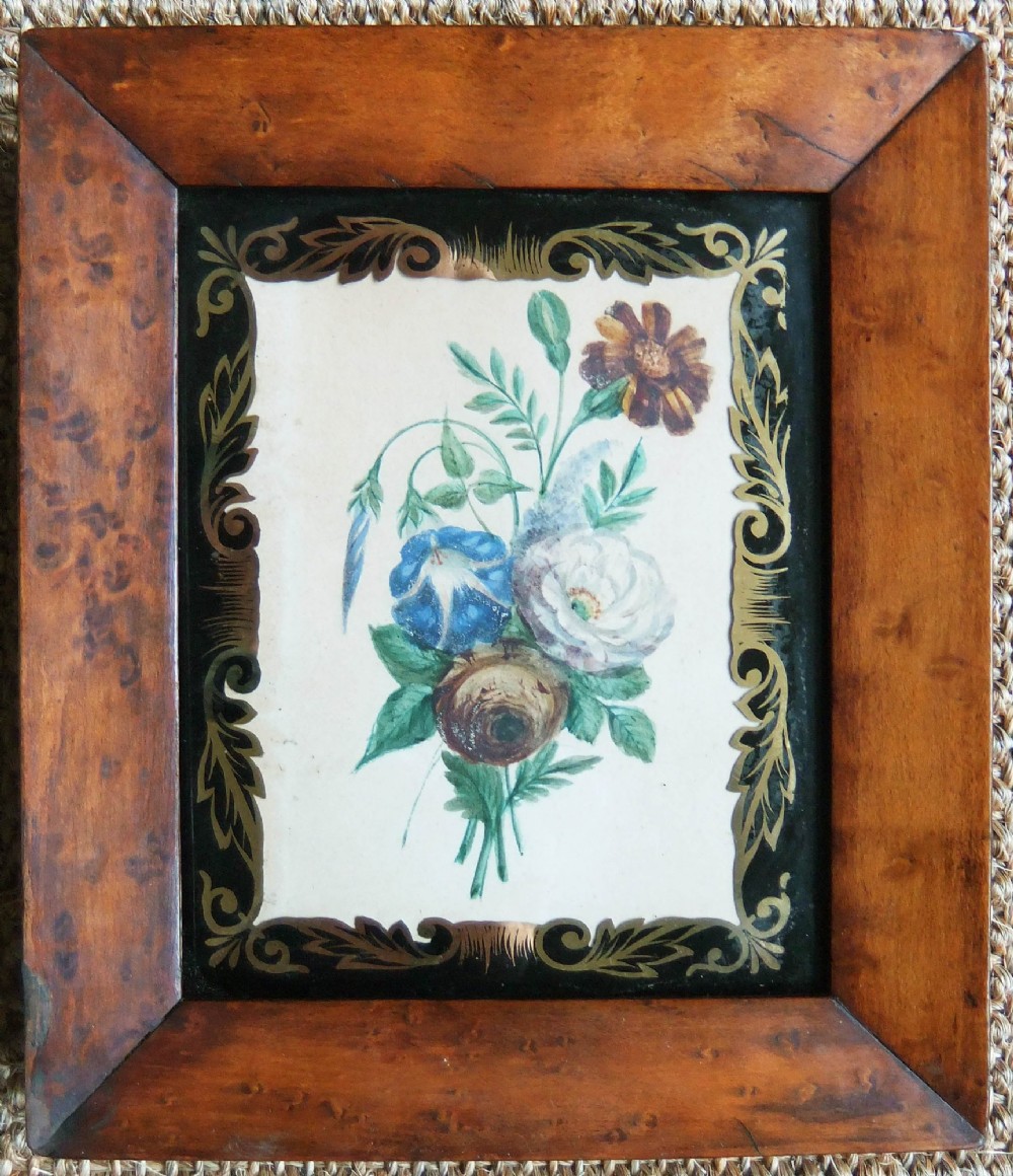 A pair of nineteenth-century botanical watercolour paintings depicting floral sprays, encased in wide birds eye maple frames with black and gold decorative glass borders. View II
