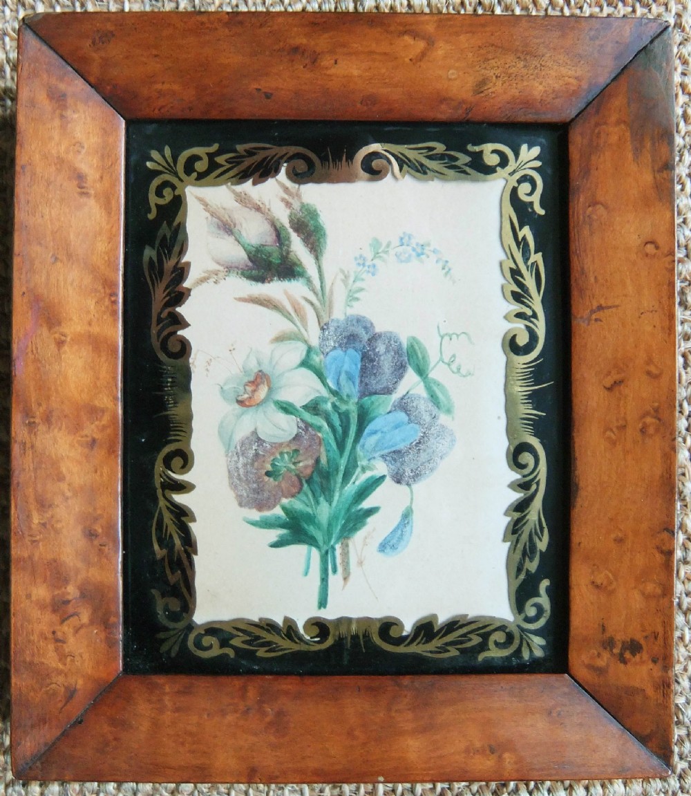 A pair of nineteenth-century botanical watercolour paintings depicting floral sprays, encased in wide birds eye maple frames with black and gold decorative glass borders. View III