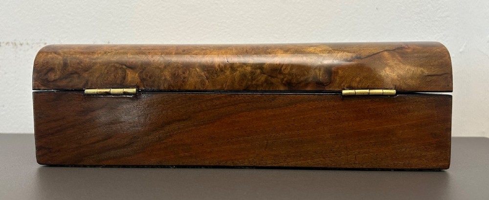 A rectangular Victorian burr walnut box featuring rounded edges, a mother-of-pearl central cartouche inlay, and a matching keyhole escutcheon. View VI