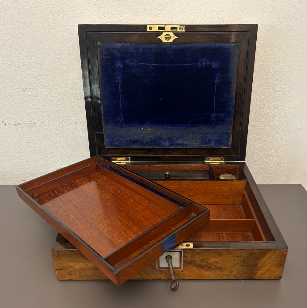 A rectangular Victorian burr walnut box featuring rounded edges, a mother-of-pearl central cartouche inlay, and a matching keyhole escutcheon. View XII