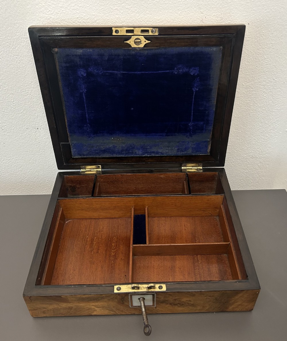 A rectangular Victorian burr walnut box featuring rounded edges, a mother-of-pearl central cartouche inlay, and a matching keyhole escutcheon. View XV