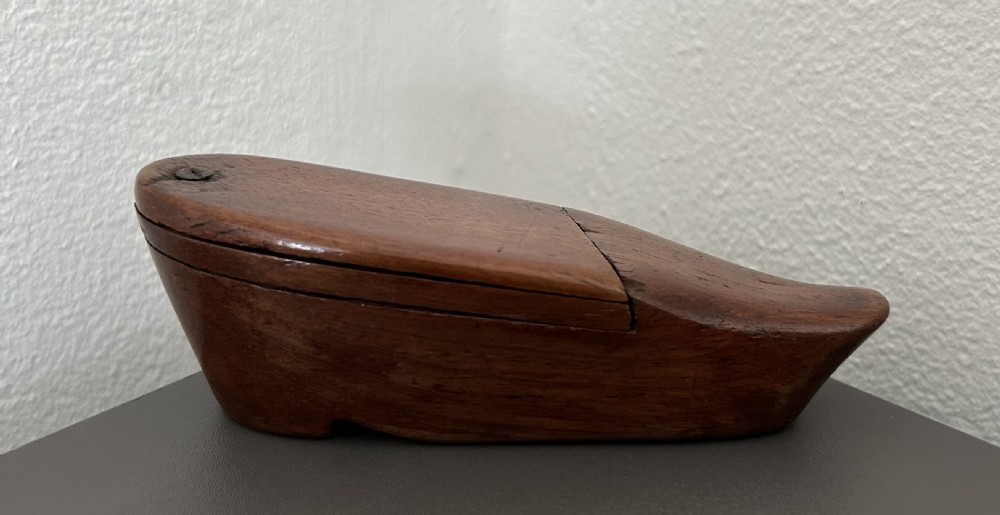 A carved mahogany novelty snuff box fashioned in the shape of a shoe with a pivoting dual-section lid. View II