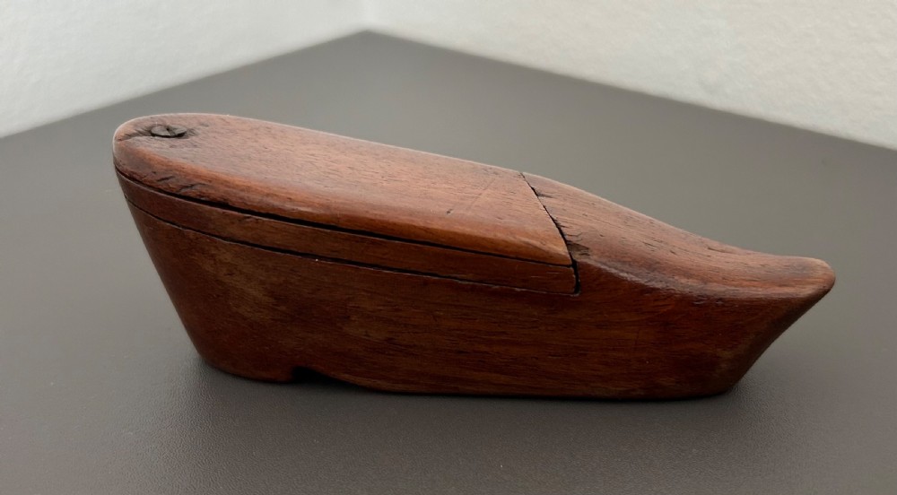 A carved mahogany novelty snuff box fashioned in the shape of a shoe with a pivoting dual-section lid. View IV