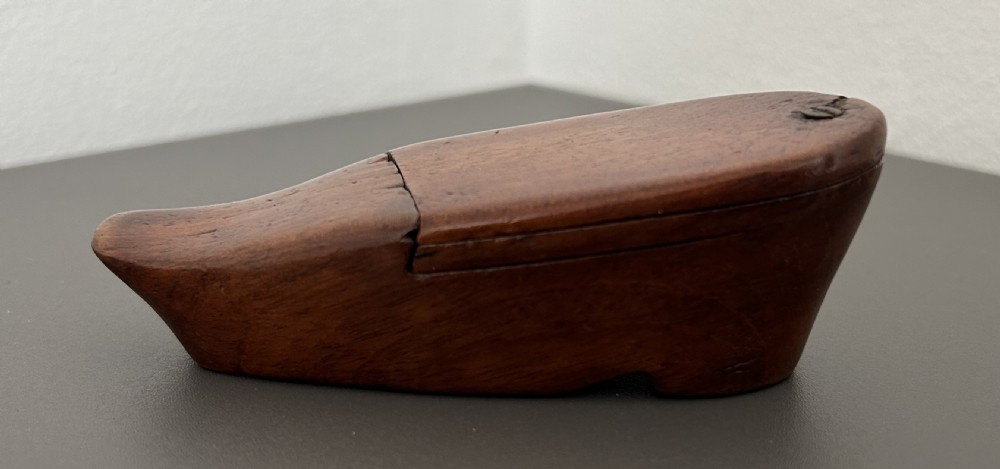 A carved mahogany novelty snuff box fashioned in the shape of a shoe with a pivoting dual-section lid. View VI
