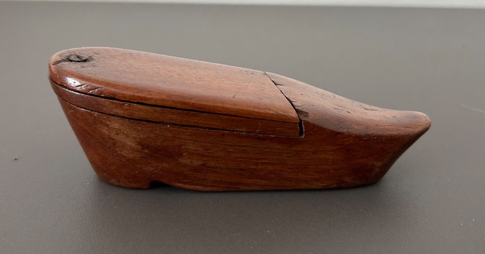 A carved mahogany novelty snuff box fashioned in the shape of a shoe with a pivoting dual-section lid. View X