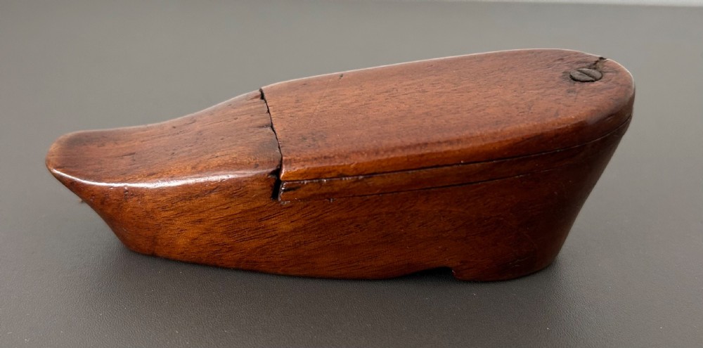 A carved mahogany novelty snuff box fashioned in the shape of a shoe with a pivoting dual-section lid. View XI