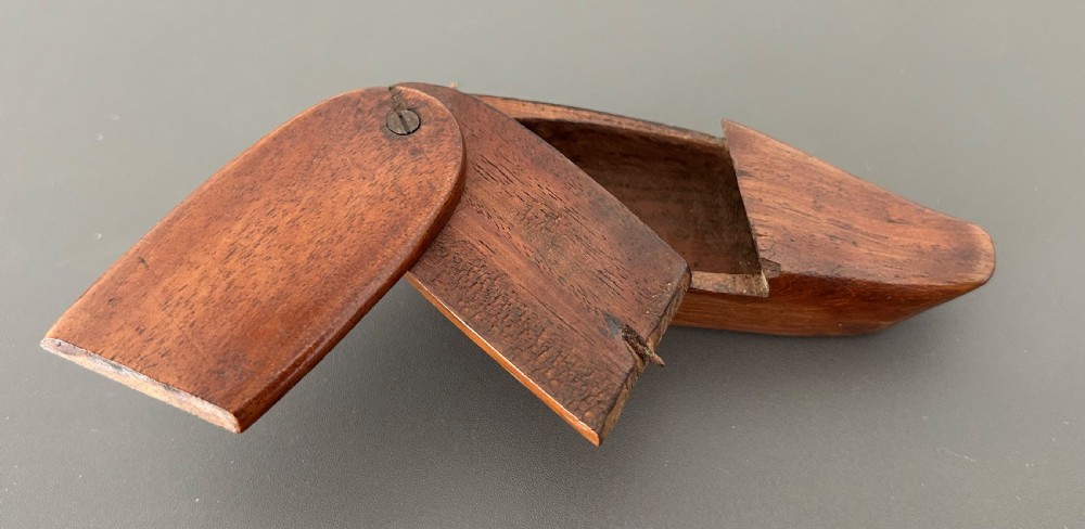 A carved mahogany novelty snuff box fashioned in the shape of a shoe with a pivoting dual-section lid. View XVI