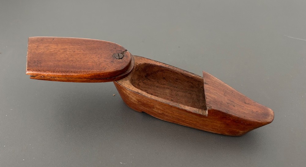 A carved mahogany novelty snuff box fashioned in the shape of a shoe with a pivoting dual-section lid. View XVIII