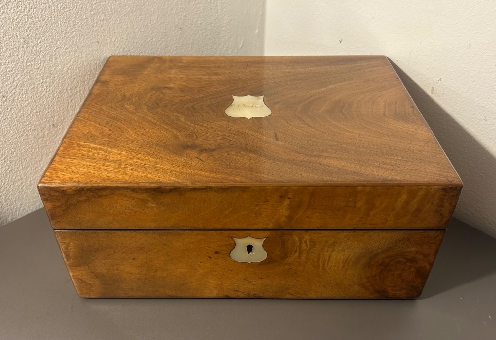 A Victorian figured walnut jewellery box with a mother-of-pearl shield cartouche on the lid and a matching escutcheon on the front. View VII
