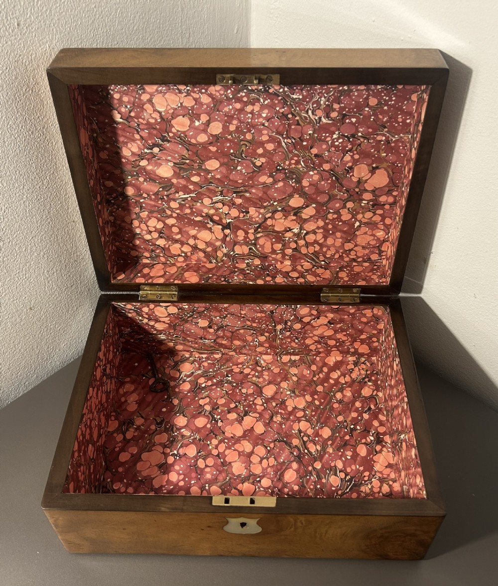 A Victorian figured walnut jewellery box with a mother-of-pearl shield cartouche on the lid and a matching escutcheon on the front. View IX