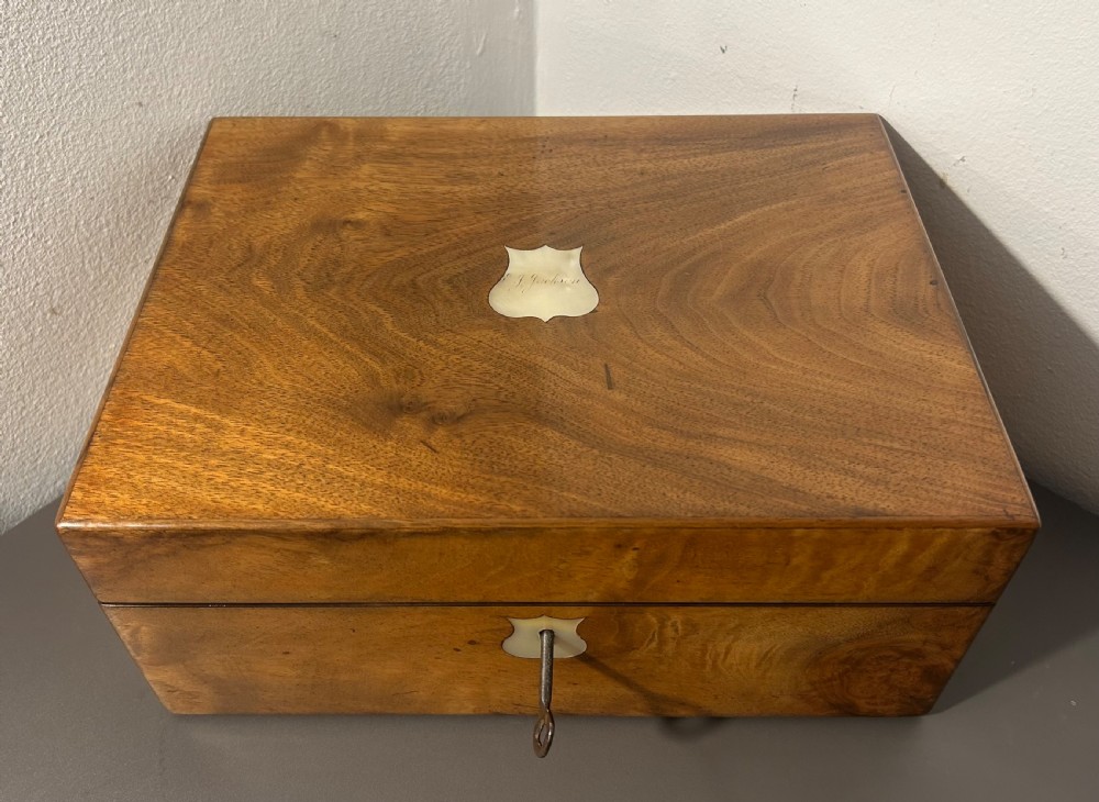 A Victorian figured walnut jewellery box with a mother-of-pearl shield cartouche on the lid and a matching escutcheon on the front. View XI