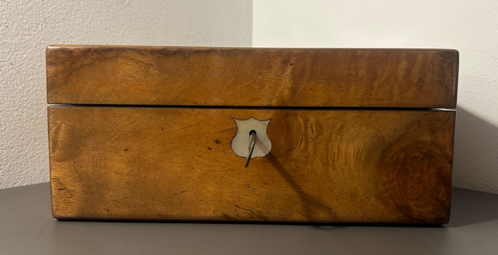 A Victorian figured walnut jewellery box with a mother-of-pearl shield cartouche on the lid and a matching escutcheon on the front. View XII