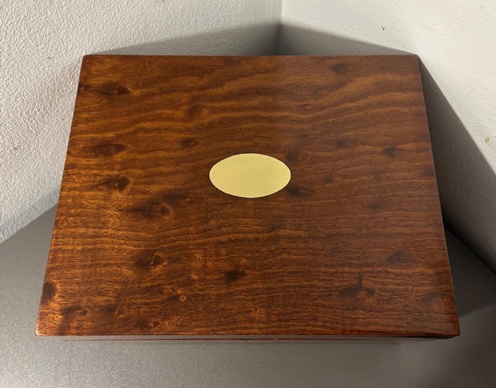 A rectangular Victorian plum mahogany jewellery box featuring a brass oval top cartouche and a matching brass keyhole escutcheon. View II