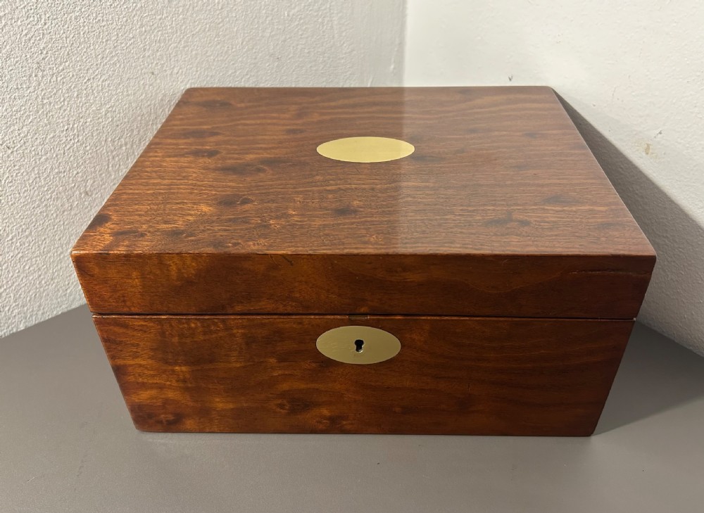 A rectangular Victorian plum mahogany jewellery box featuring a brass oval top cartouche and a matching brass keyhole escutcheon. View III