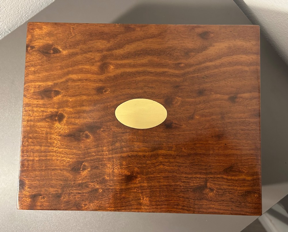 A rectangular Victorian plum mahogany jewellery box featuring a brass oval top cartouche and a matching brass keyhole escutcheon. View IV