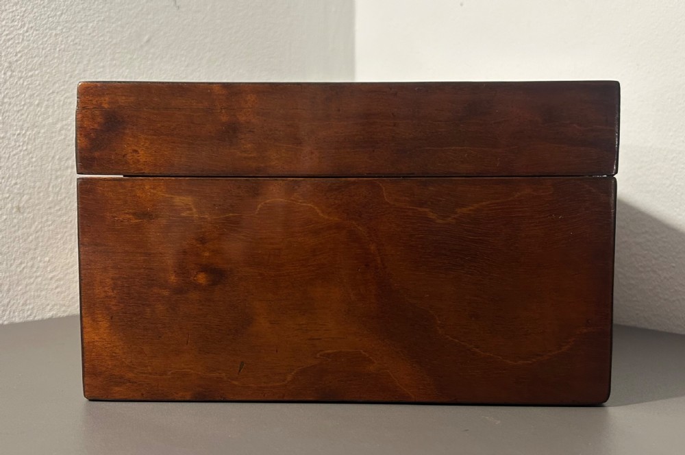 A rectangular Victorian plum mahogany jewellery box featuring a brass oval top cartouche and a matching brass keyhole escutcheon. View VIII