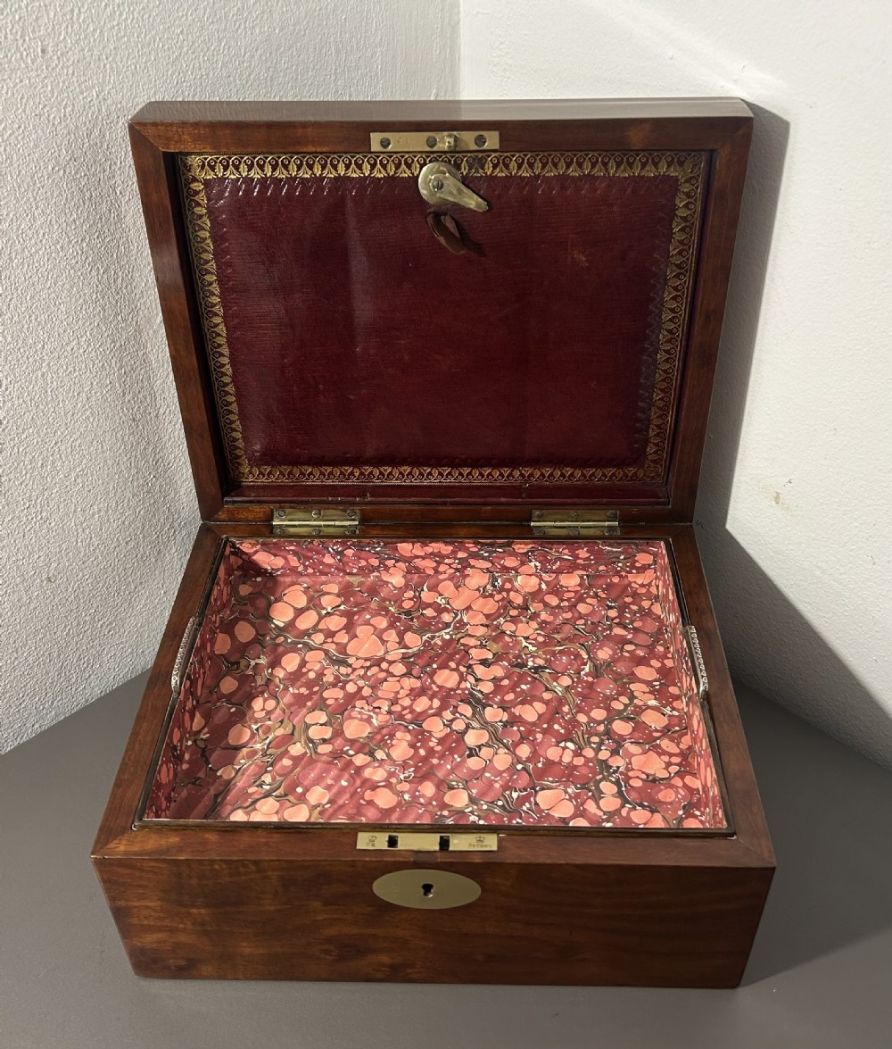 A rectangular Victorian plum mahogany jewellery box featuring a brass oval top cartouche and a matching brass keyhole escutcheon. View XII