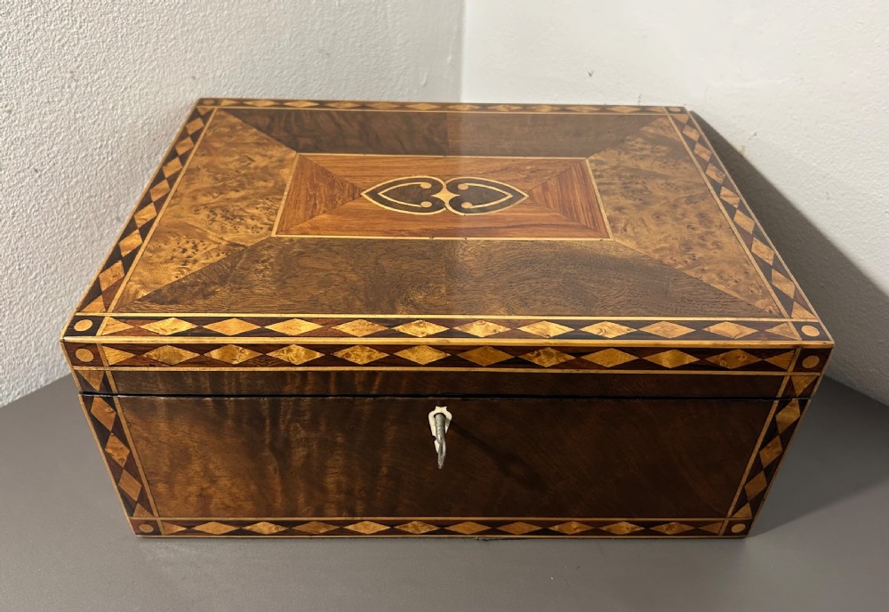 A rectangular Victorian specimen wood box featuring geometric parquetry inlay, a central heart motif on the lid, and a keyhole on the front. View II