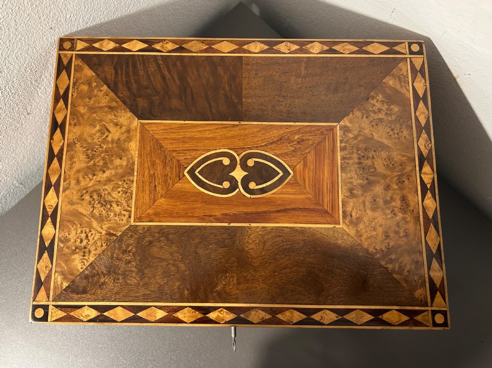 A rectangular Victorian specimen wood box featuring geometric parquetry inlay, a central heart motif on the lid, and a keyhole on the front. View III