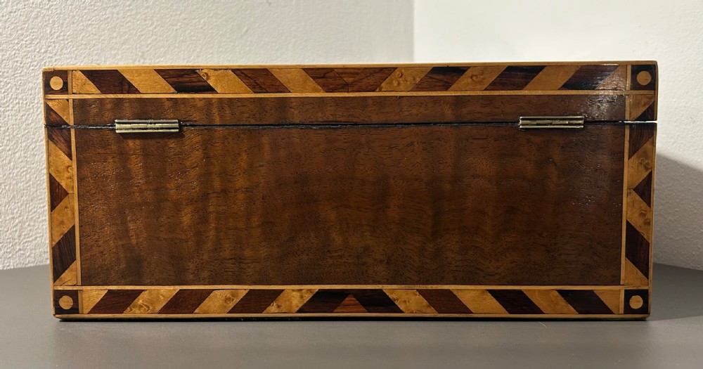 A rectangular Victorian specimen wood box featuring geometric parquetry inlay, a central heart motif on the lid, and a keyhole on the front. View VIII