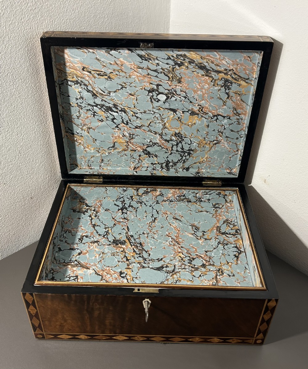 A rectangular Victorian specimen wood box featuring geometric parquetry inlay, a central heart motif on the lid, and a keyhole on the front. View XII