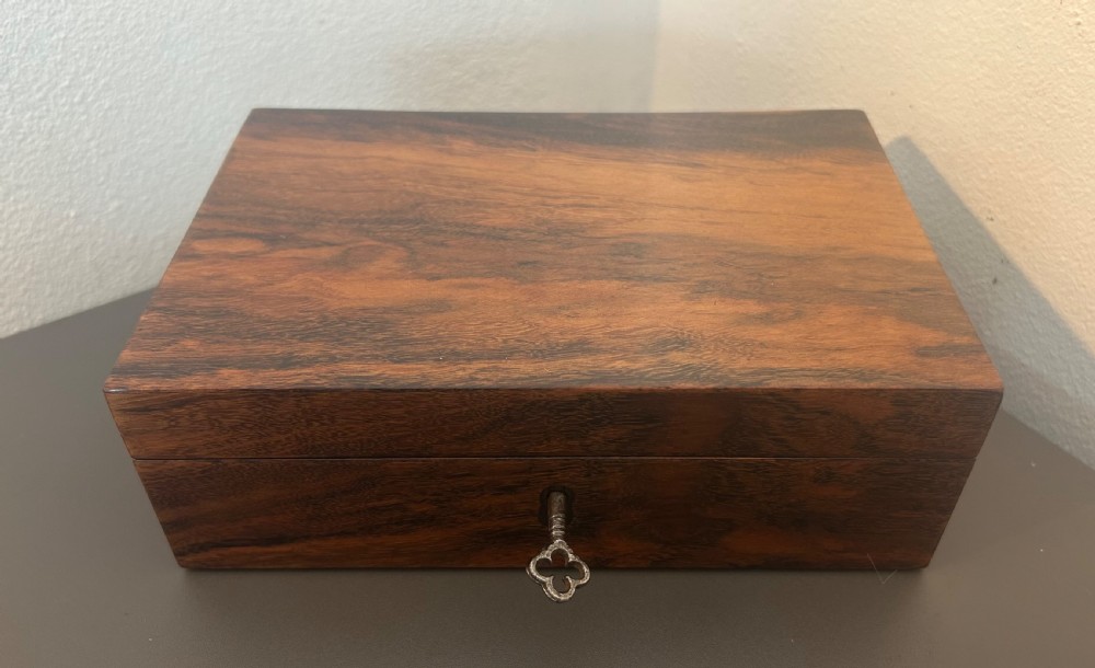 A rectangular Victorian table box featuring highly figured laburnum wood veneer and a central keyhole with key. View II