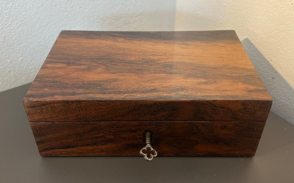 A rectangular Victorian table box featuring highly figured laburnum wood veneer and a central keyhole with key. View III