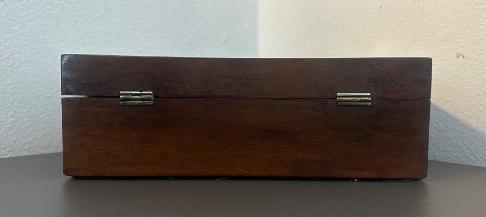 A rectangular Victorian table box featuring highly figured laburnum wood veneer and a central keyhole with key. View V