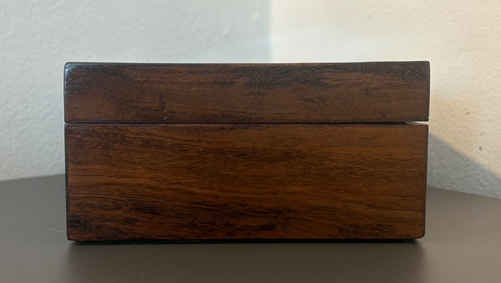 A rectangular Victorian table box featuring highly figured laburnum wood veneer and a central keyhole with key. View VI