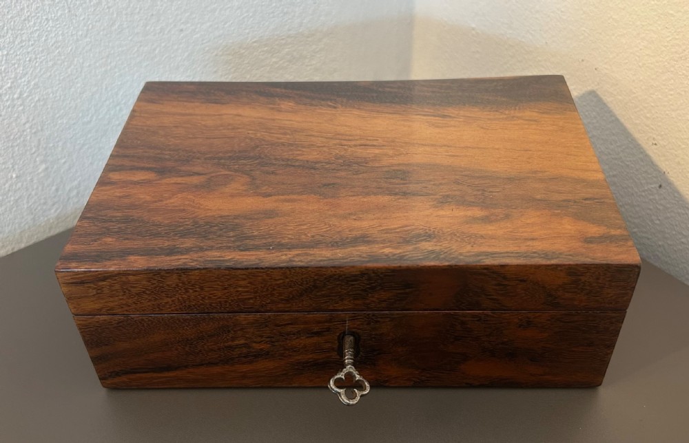 A rectangular Victorian table box featuring highly figured laburnum wood veneer and a central keyhole with key. View IX