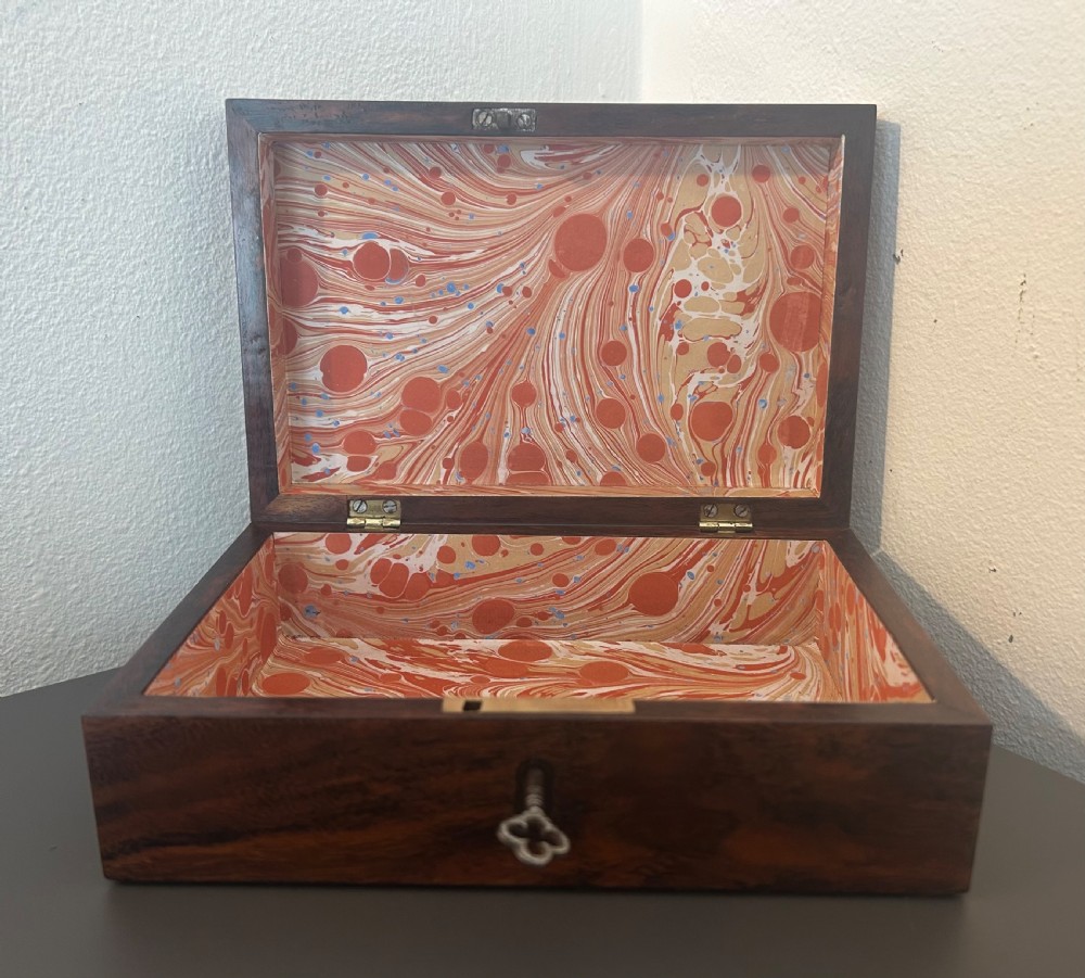 A rectangular Victorian table box featuring highly figured laburnum wood veneer and a central keyhole with key. View X