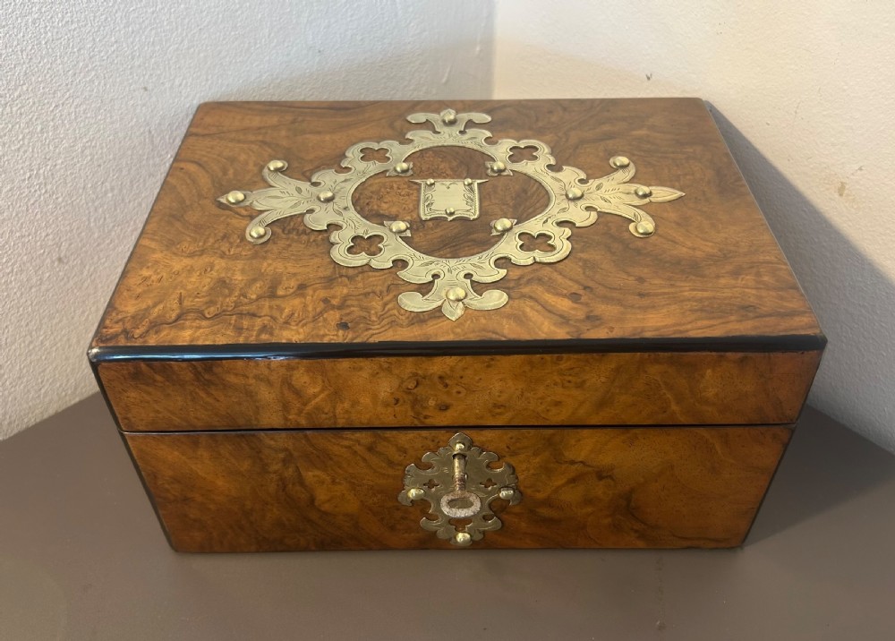 Victorian burr walnut jewellery box featuring ornate engraved brass strapwork and a keyhole escutcheon. View II