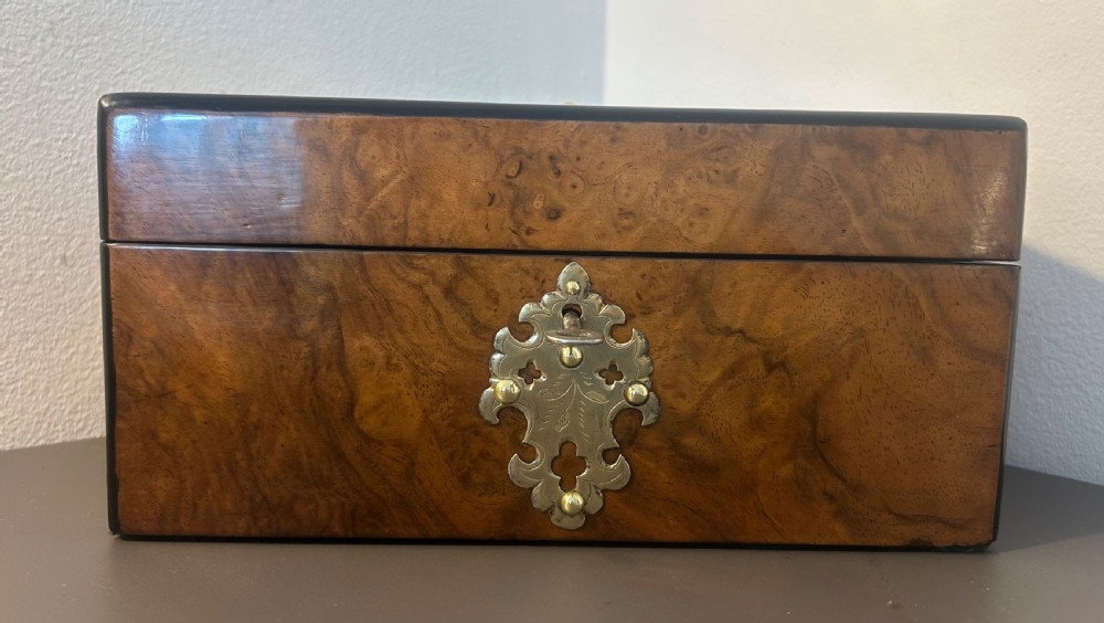 Victorian burr walnut jewellery box featuring ornate engraved brass strapwork and a keyhole escutcheon. View III