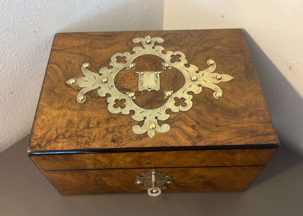 Victorian burr walnut jewellery box featuring ornate engraved brass strapwork and a keyhole escutcheon. View IV