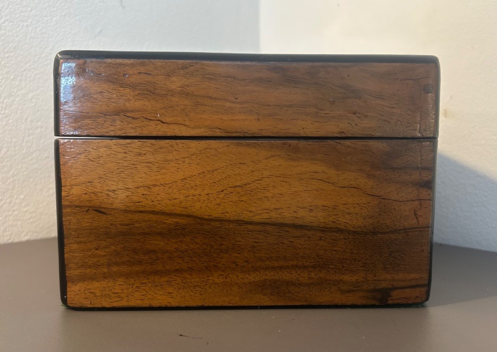 Victorian burr walnut jewellery box featuring ornate engraved brass strapwork and a keyhole escutcheon. View V