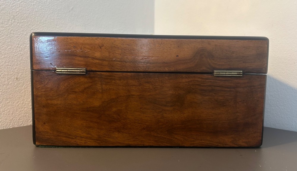 Victorian burr walnut jewellery box featuring ornate engraved brass strapwork and a keyhole escutcheon. View VI
