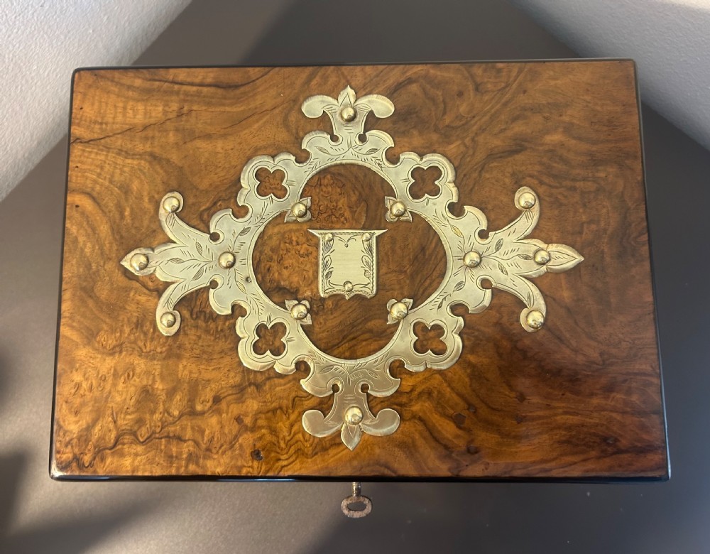 Victorian burr walnut jewellery box featuring ornate engraved brass strapwork and a keyhole escutcheon. View VIII