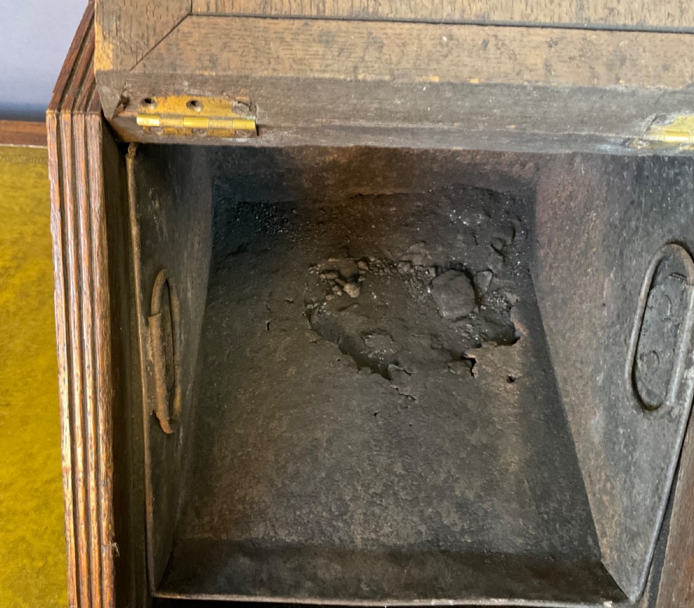 A Victorian carved oak coal scuttle featuring a brass top handle and a sloped front panel relief-carved with a mythical sea creature. View VII