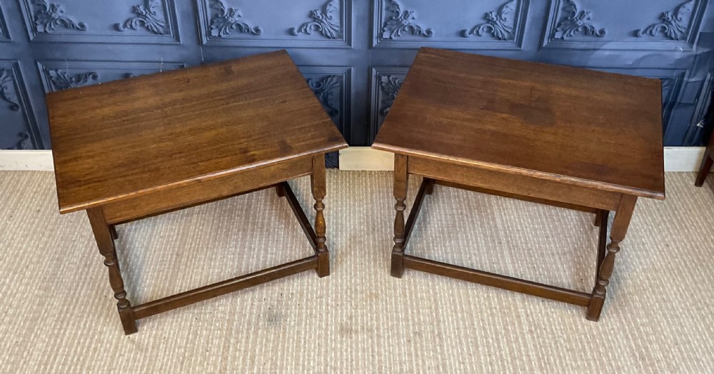 A matching pair of dark oak rectangular coffee tables featuring turned legs and low perimeter stretchers. View II