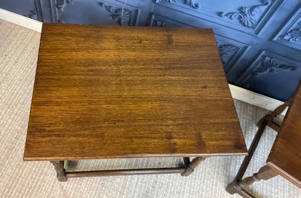 A matching pair of dark oak rectangular coffee tables featuring turned legs and low perimeter stretchers. View III