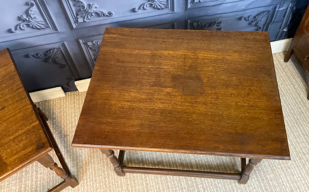 A matching pair of dark oak rectangular coffee tables featuring turned legs and low perimeter stretchers. View V