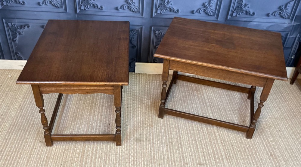 A matching pair of dark oak rectangular coffee tables featuring turned legs and low perimeter stretchers. View VI