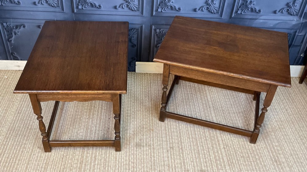 A matching pair of dark oak rectangular coffee tables featuring turned legs and low perimeter stretchers. View VII