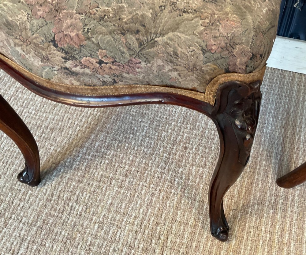 A pair of Victorian carved dark wood side chairs featuring open-work balloon backs, patterned tapestry upholstered seats, and cabriole legs. View XI