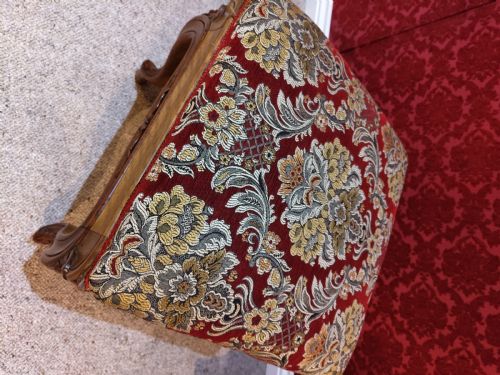 fig 1. An antique carved walnut piano stool with cabriole legs and a red floral tapestry upholstered top.