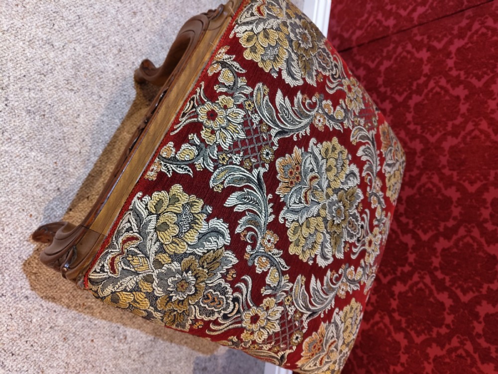 An antique carved walnut piano stool with cabriole legs and a red floral tapestry upholstered top. View II